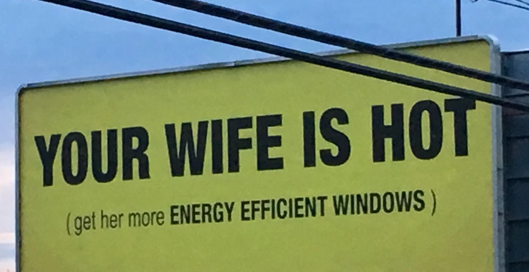Billboard saying “Your wife is hot, get her more energy efficient windows”