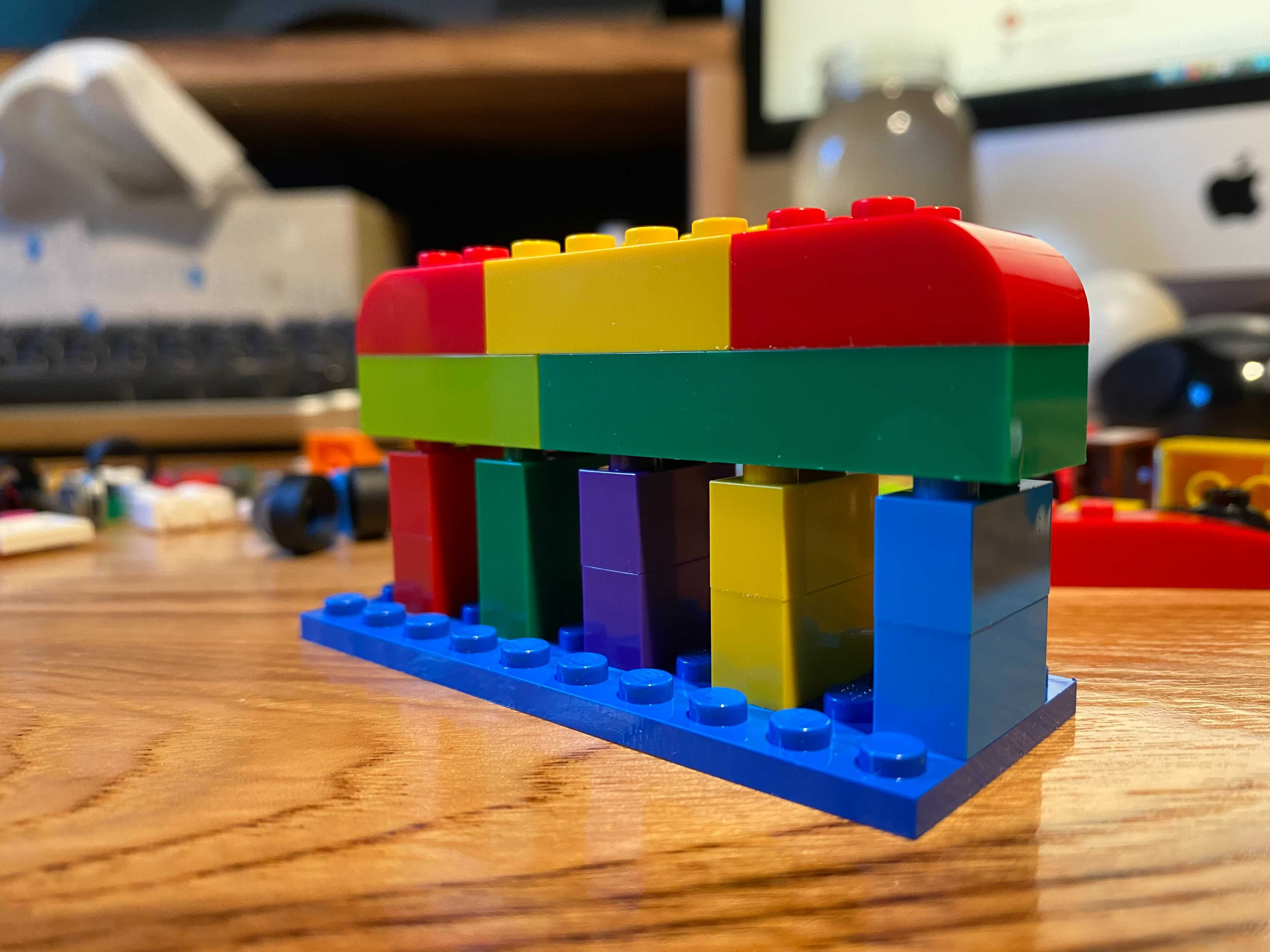 Some legos representing "Live as one team with one mission" in an abstract way.